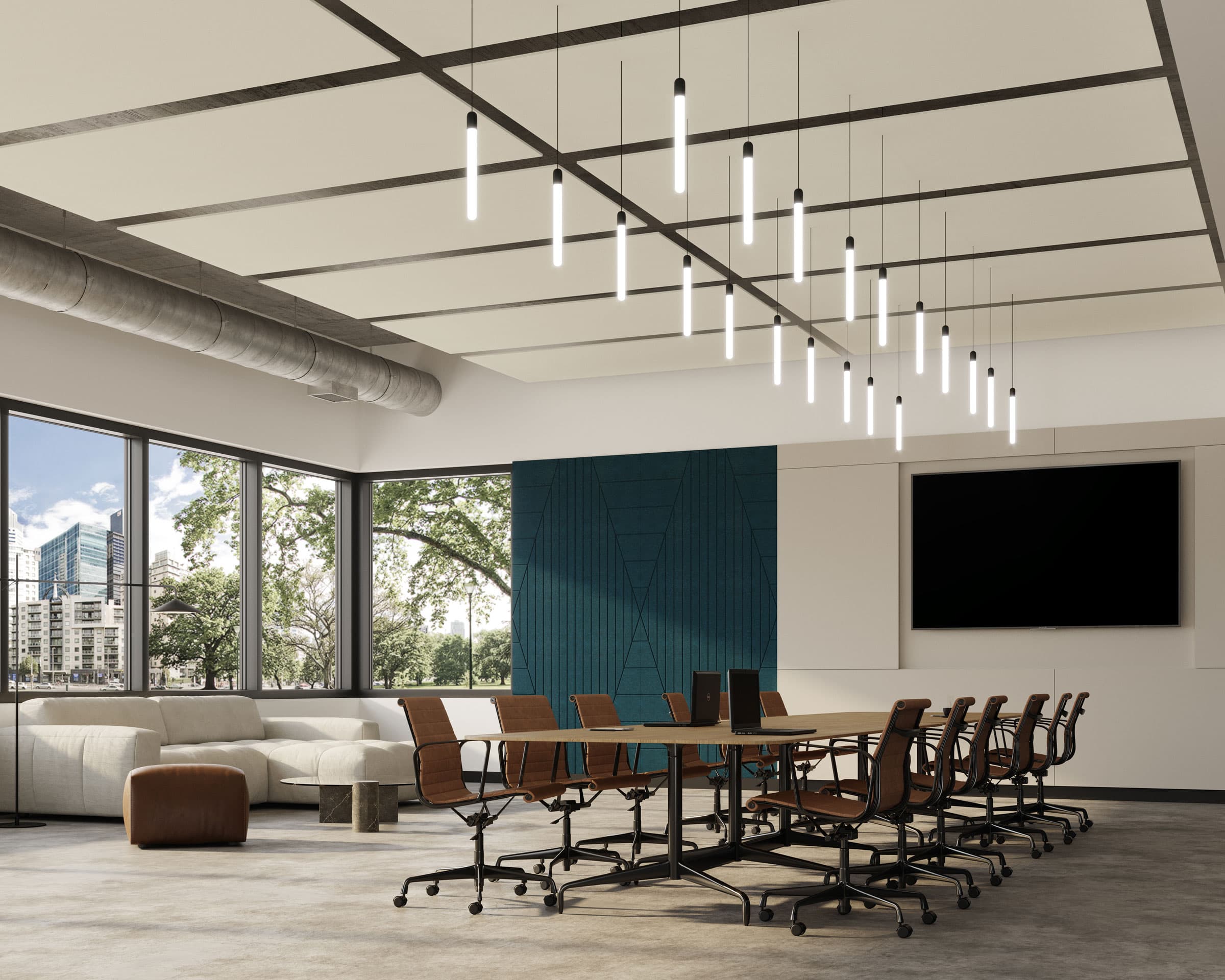 A modern conference room with a long wooden table surrounded by black office chairs. Above the table hang minimalist pendant lights and rectangle acoustic felt ceiling clouds. The room features large windows, a blue accent wall, a wall-mounted screen, and a white sofa with a brown ottoman.