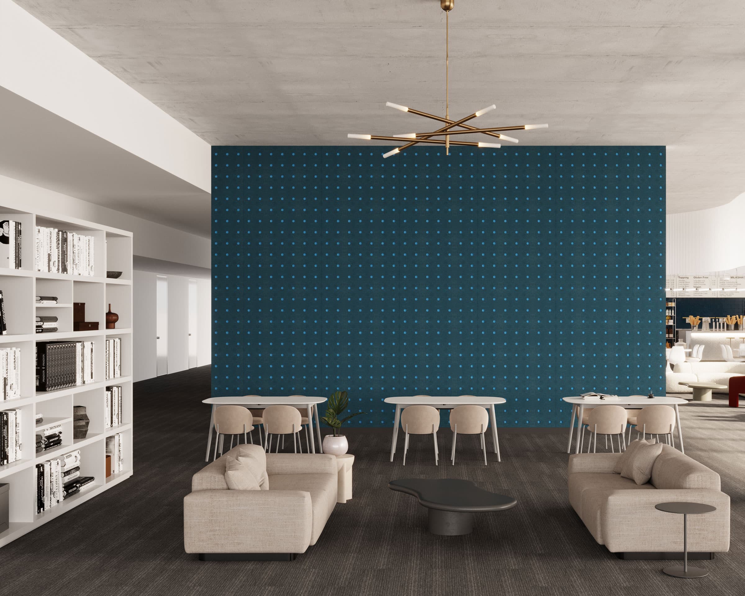 A modern lounge area featuring light beige armchairs and sofas around a black coffee table. The space has a blue acoustic felt accent wall with small circles cut out, multiple small tables and chairs, a bookshelf on the left, and a gold mid-century modern chandelier above.