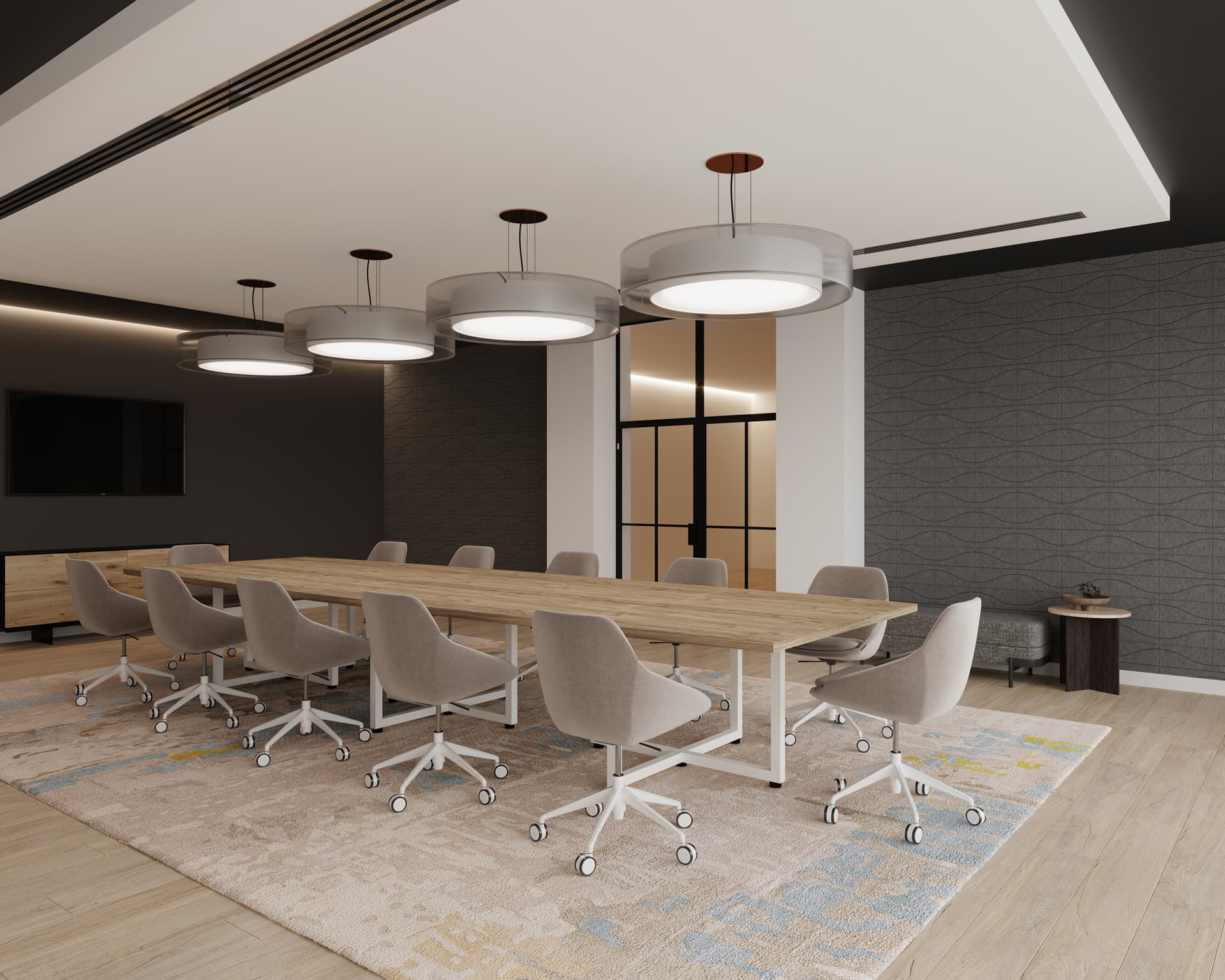 A modern conference room features a large wooden table surrounded by gray chairs on wheels. Overhead, four large circular pendant lights hang from the ceiling. The room boasts gray patterned walls with acoustic felt wall tiles and a door with a glass panel. A textured rug covers the floor.