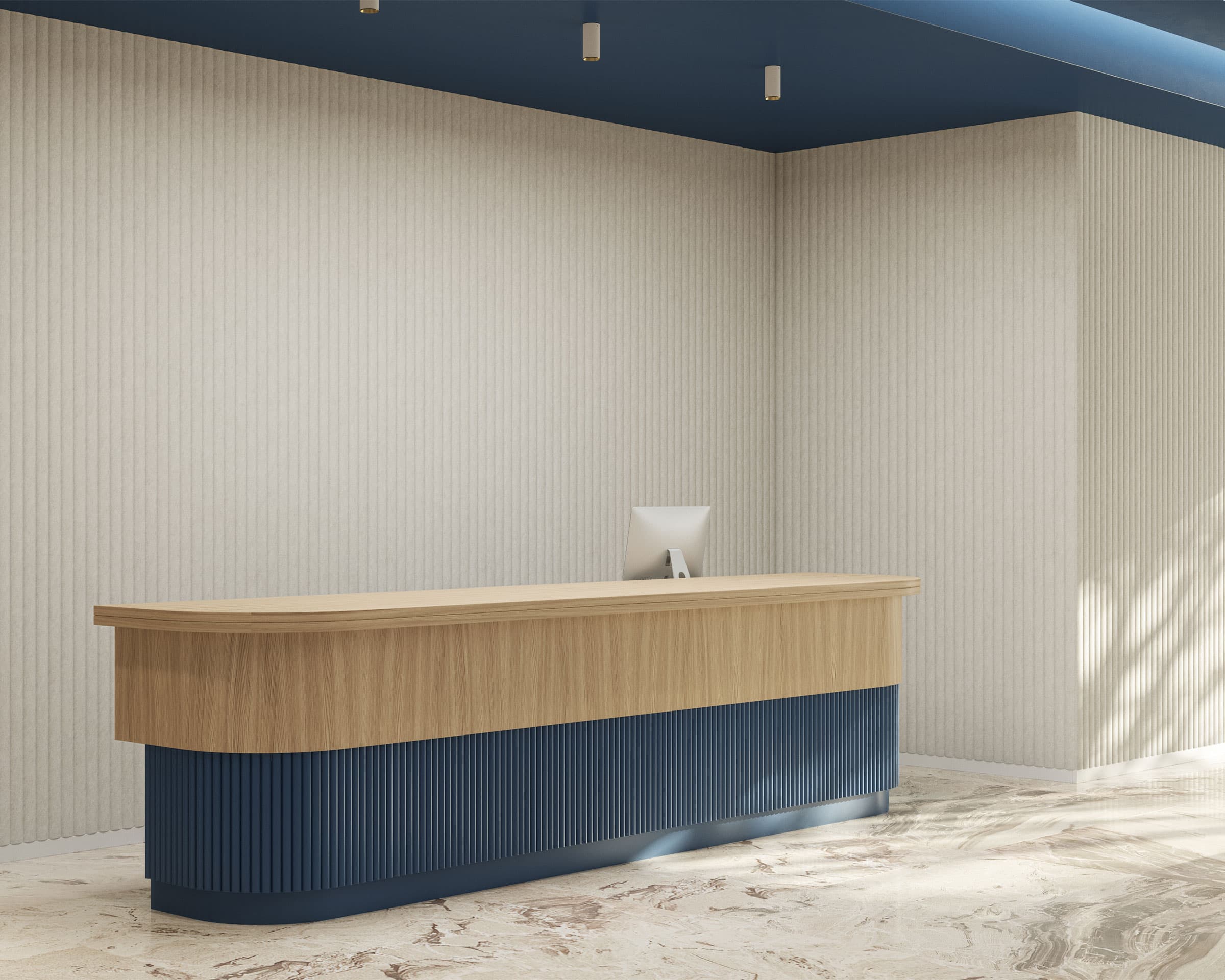 A modern reception area featuring a curved wooden desk with a blue base. The desk has a computer monitor on it, and the background consists of light-colored textured walls with celestial acoustic felt wall panels and a light-colored marble floor. Overhead, part of the ceiling is painted blue with spotlights.