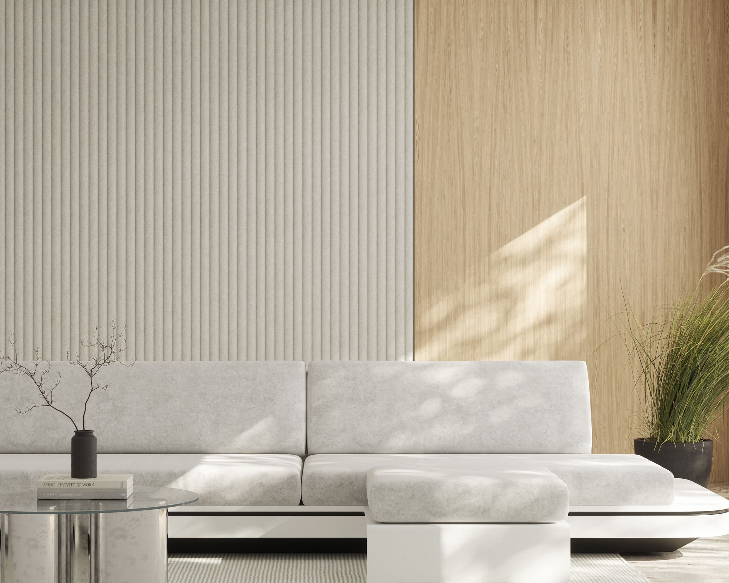 Modern living room with a minimalist white couch and matching ottoman on a light-colored rug. The wall features a contrast of celestial acoustic felt wall panels and smooth wooden panels. A tall green plant in a black pot sits beside the couch, while a small table is in the foreground.