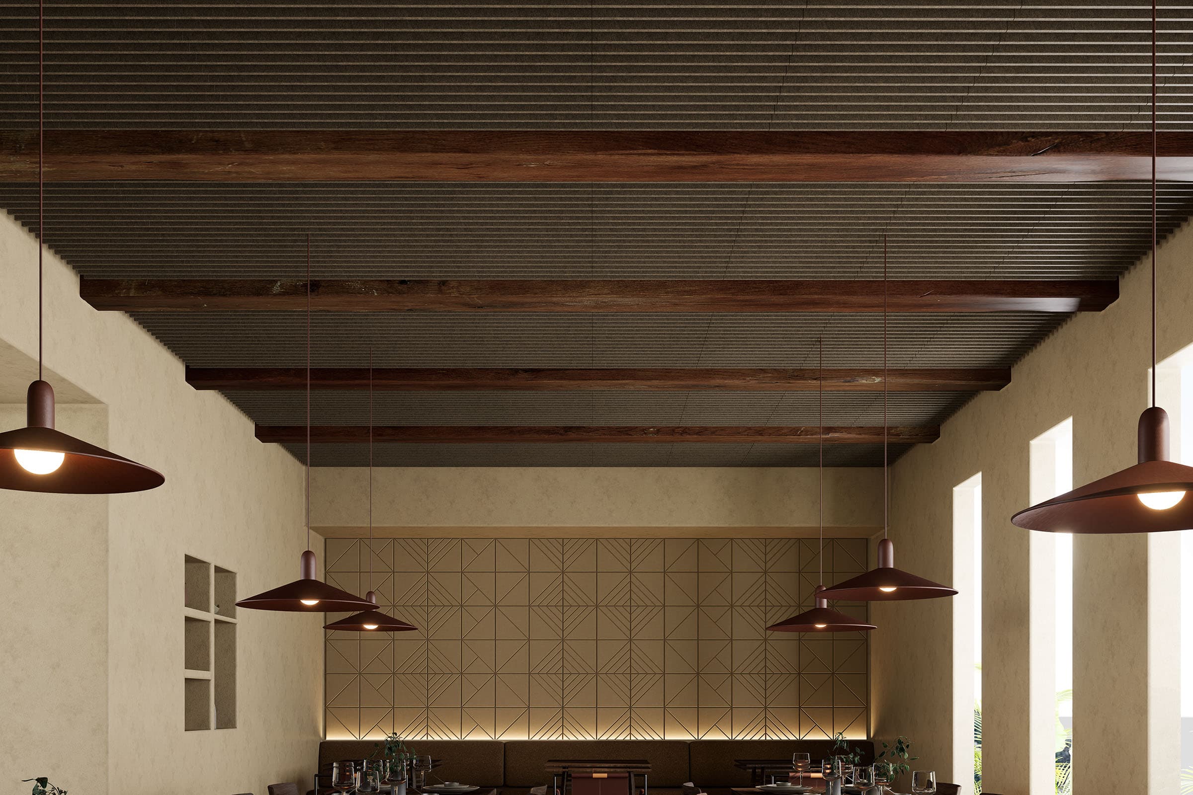 A spacious, contemporary indoor dining area featuring modern pendant lights. Large windows illuminate neatly arranged tables and chairs with a minimalist design. Acoustic felt ceiling panels subtly enhance the earthy color palette of the space.