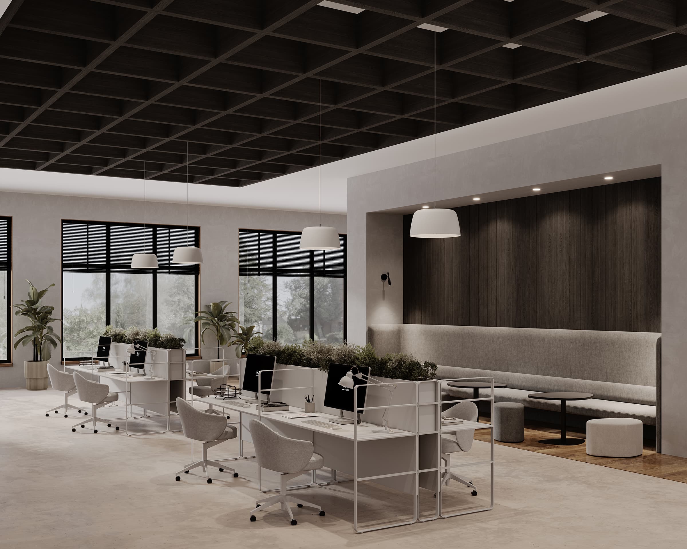 A modern office space with an open-plan design, featuring workstations with chairs and desktop computers. The ceiling boasts a dark grid framework with acoustic felt and hanging white lamps. To the right, a seating area offers a bench and small round tables. Large windows provide natural light.