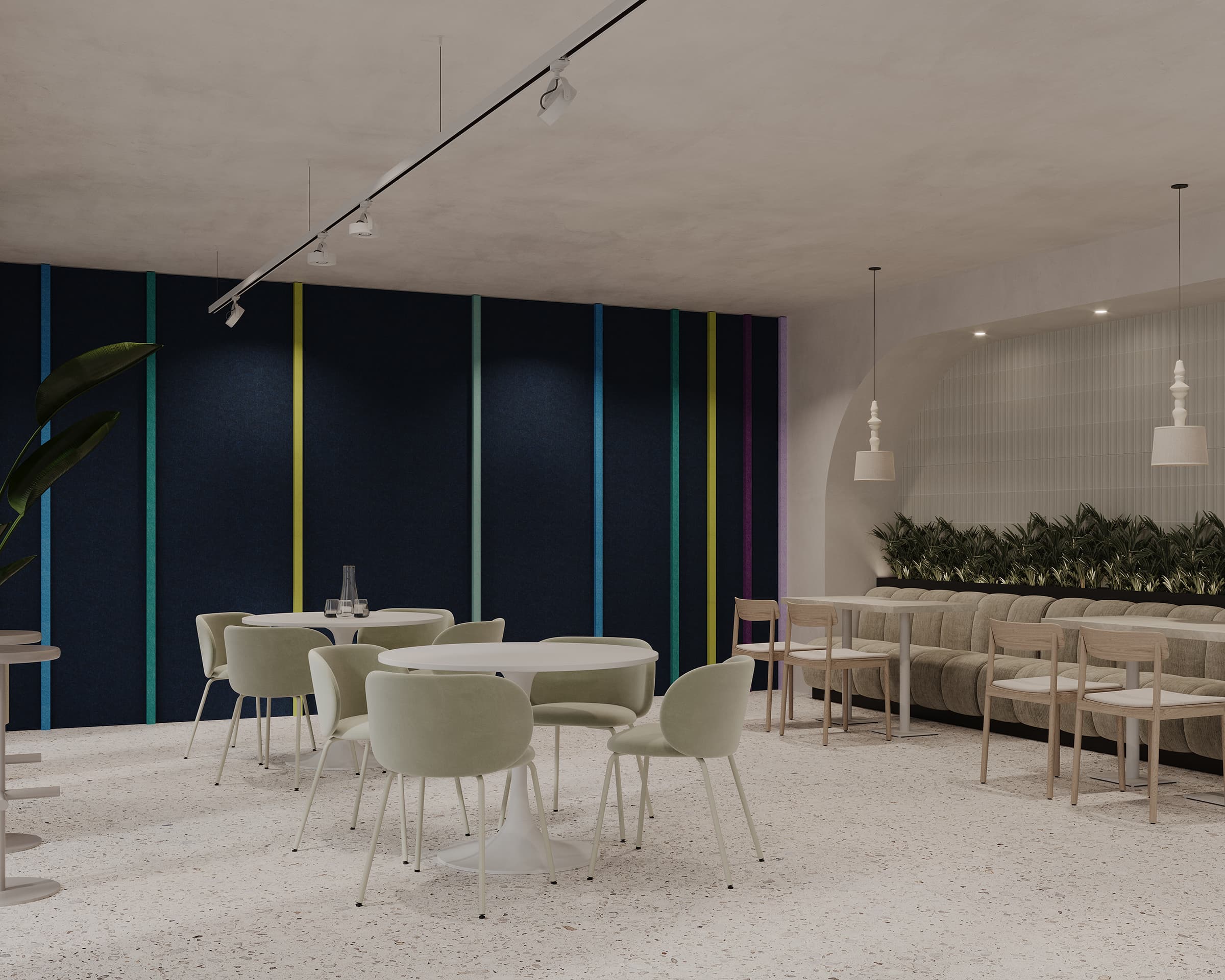 A modern cafe interior featuring light green chairs around circular tables. The wall on the left is adorned with vertical colorful stripes against an acoustic felt background, while the right side has a beige cushioned bench with plants behind it. Pendant lights hang from the ceiling, enhancing the ambiance and seamless design.