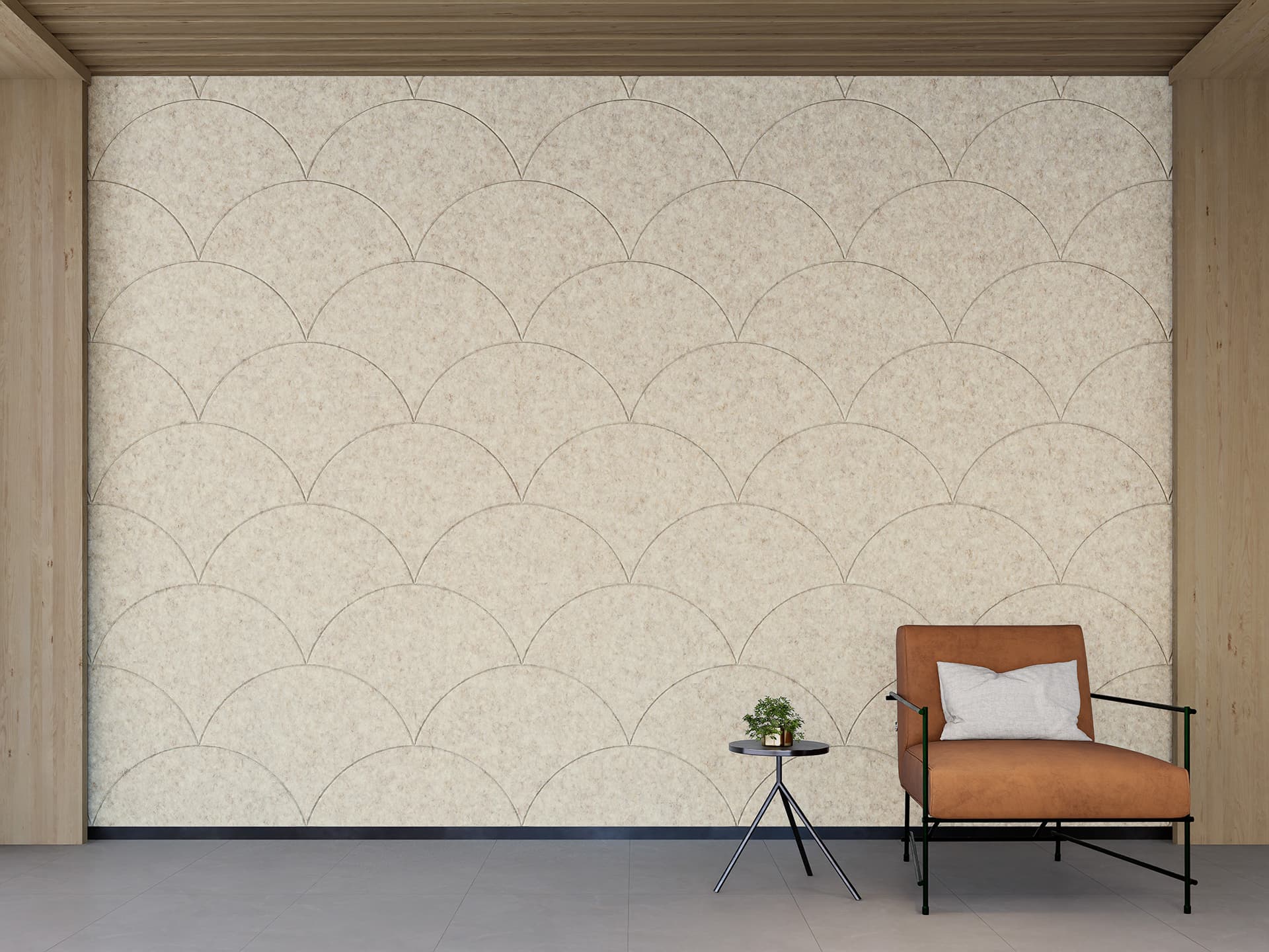 A minimalist room featuring a beige arched-patterned acoustic felt wall, a brown upholstered chair with a white pillow, and a small black side table holding a plant. The room has a grey floor and wooden trim on the walls and ceiling.