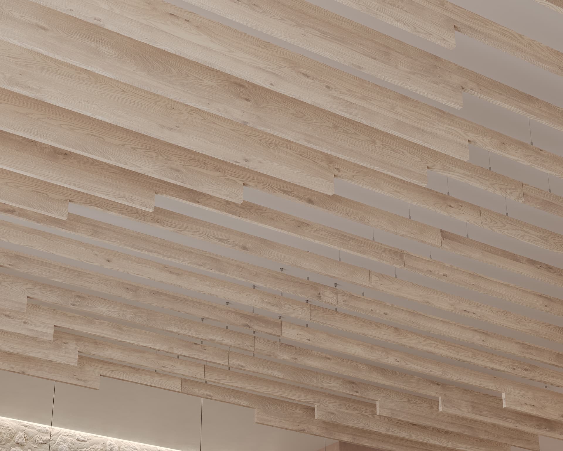A modern ceiling featuring staggered acoustic felt slats arranged parallel to each other, creating a sleek, linear pattern. The light wood tones contribute to a warm, contemporary ambiance while shadows cast by the slats add depth and visual interest to the design.