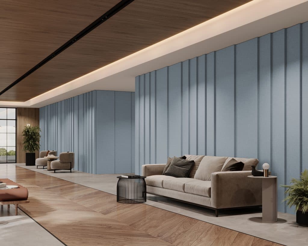 A modern interior features a spacious room with light blue acoustic felt textured walls, a beige sofa, and two armchairs. The wooden floor has a geometric pattern, and potted plants add greenery. Large windows let in natural light.