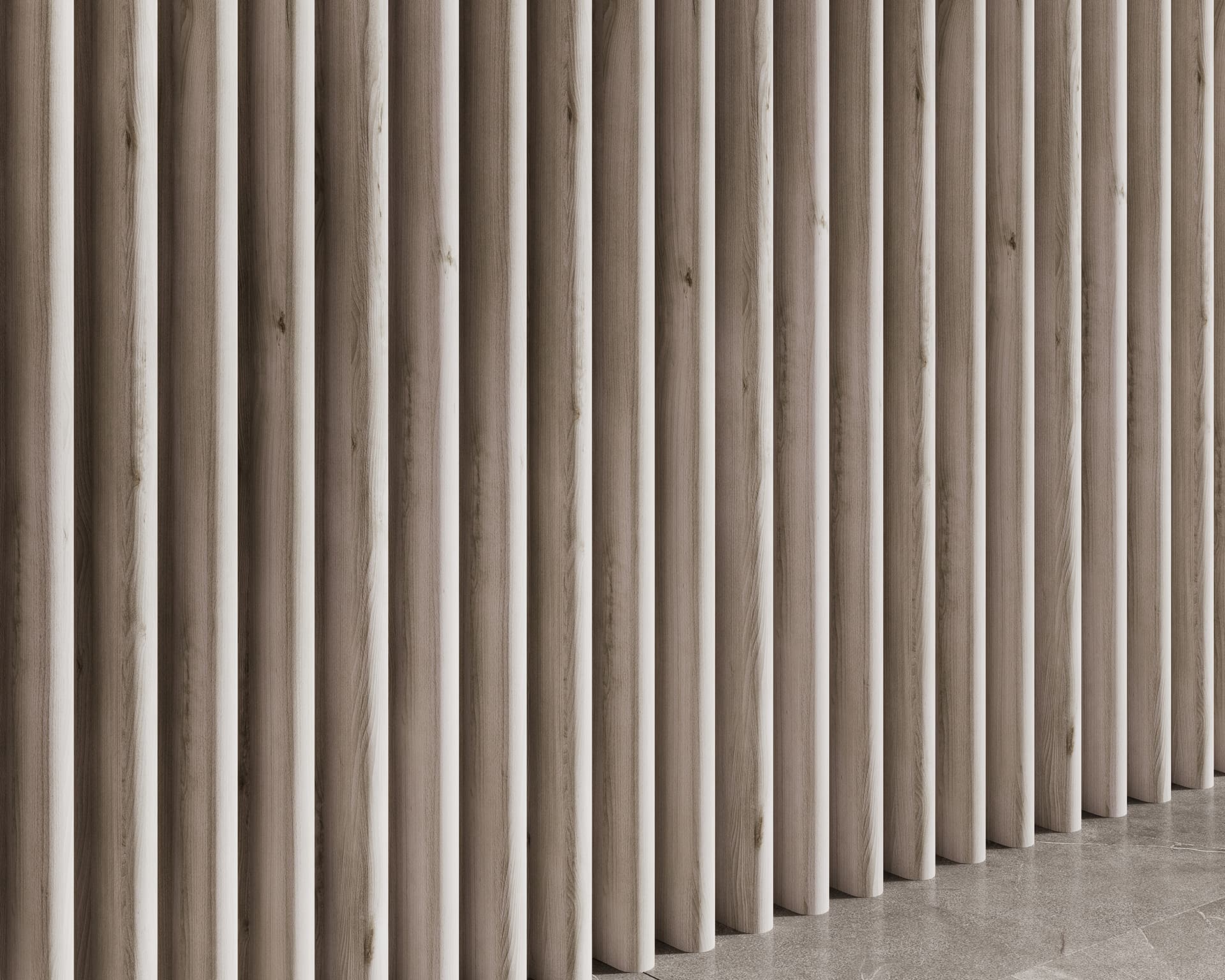 Woodgrain vertical acoustic felt slats create a modern, minimalist wall partition. The slats are evenly spaced and extend from floor to ceiling, casting subtle shadows on a shiny, light gray floor. The woodgrain texture adds a natural element to the design.