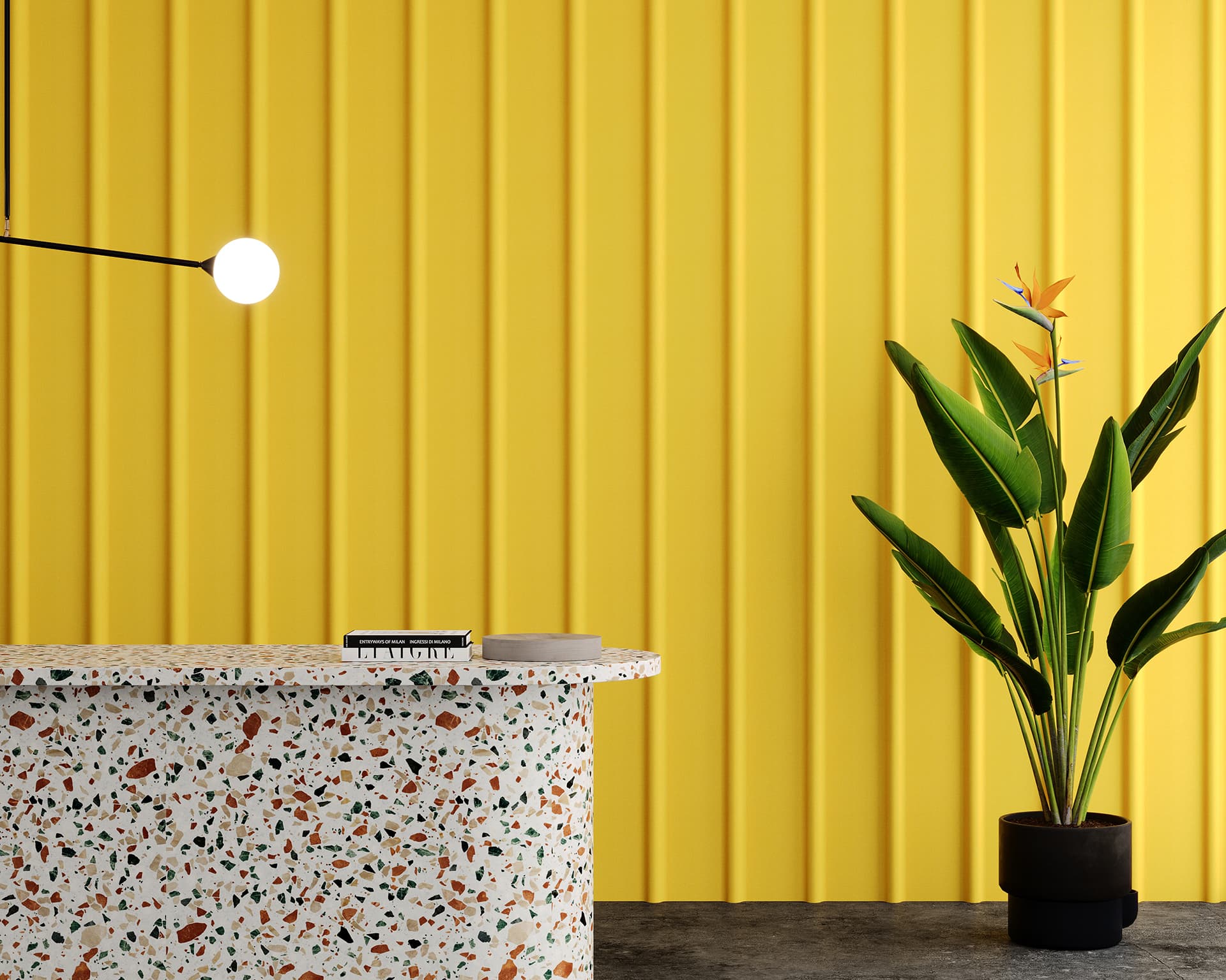 A modern interior showcases a terrazzo counter with colorful specks in front of a bright yellow, vertical acoustic felt ribbed wall adorned. A potted bird of paradise is on the right, while above, a spherical lamp provides elegant illumination.