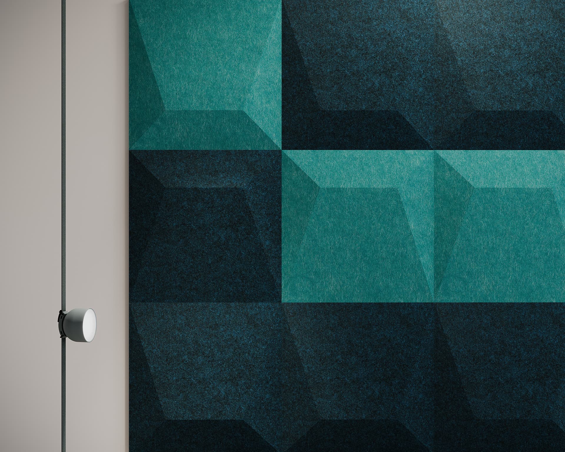 Geometric acoustic felt wall pattern with teal and dark green panels creates a 3D cube illusion, adjacent to a minimalistic light fixture on a plain wall.