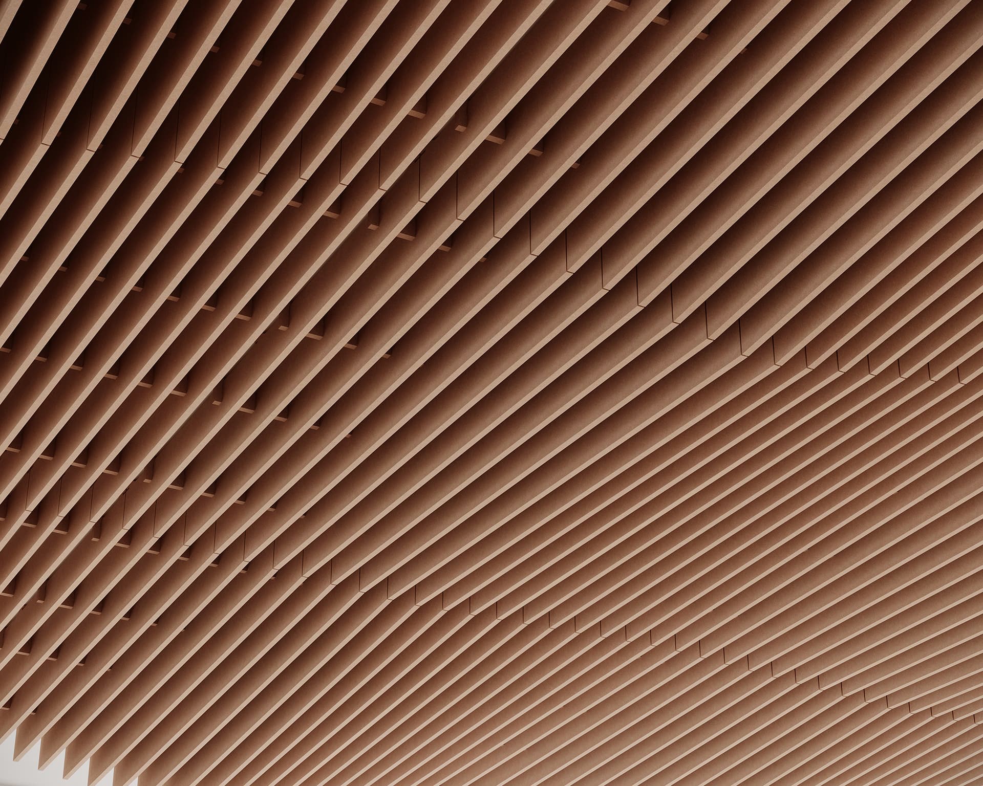 Close-up view of a geometric acoustic felt ceiling with uniformly spaced, parallel slats creating a repetitive pattern. The slats form a textured grid, casting subtle shadows and adding depth to the otherwise neutral-toned surface.