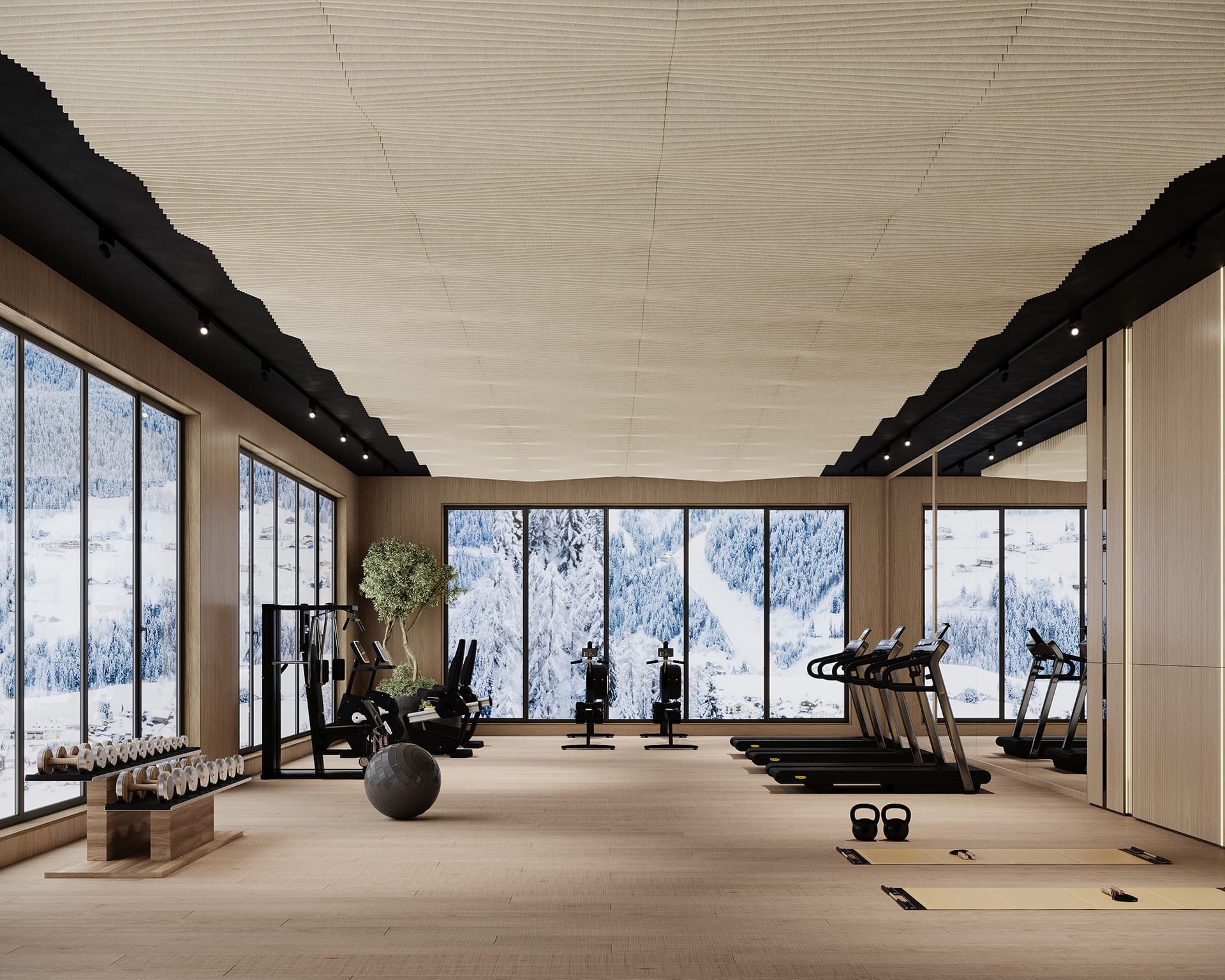 A modern gym with large windows showcasing a snowy mountain view. The room features treadmills, stationary bikes, exercise mats, weights, a stability ball, and a tree. The interior is bright with wooden flooring and an acoustic felt ceiling.