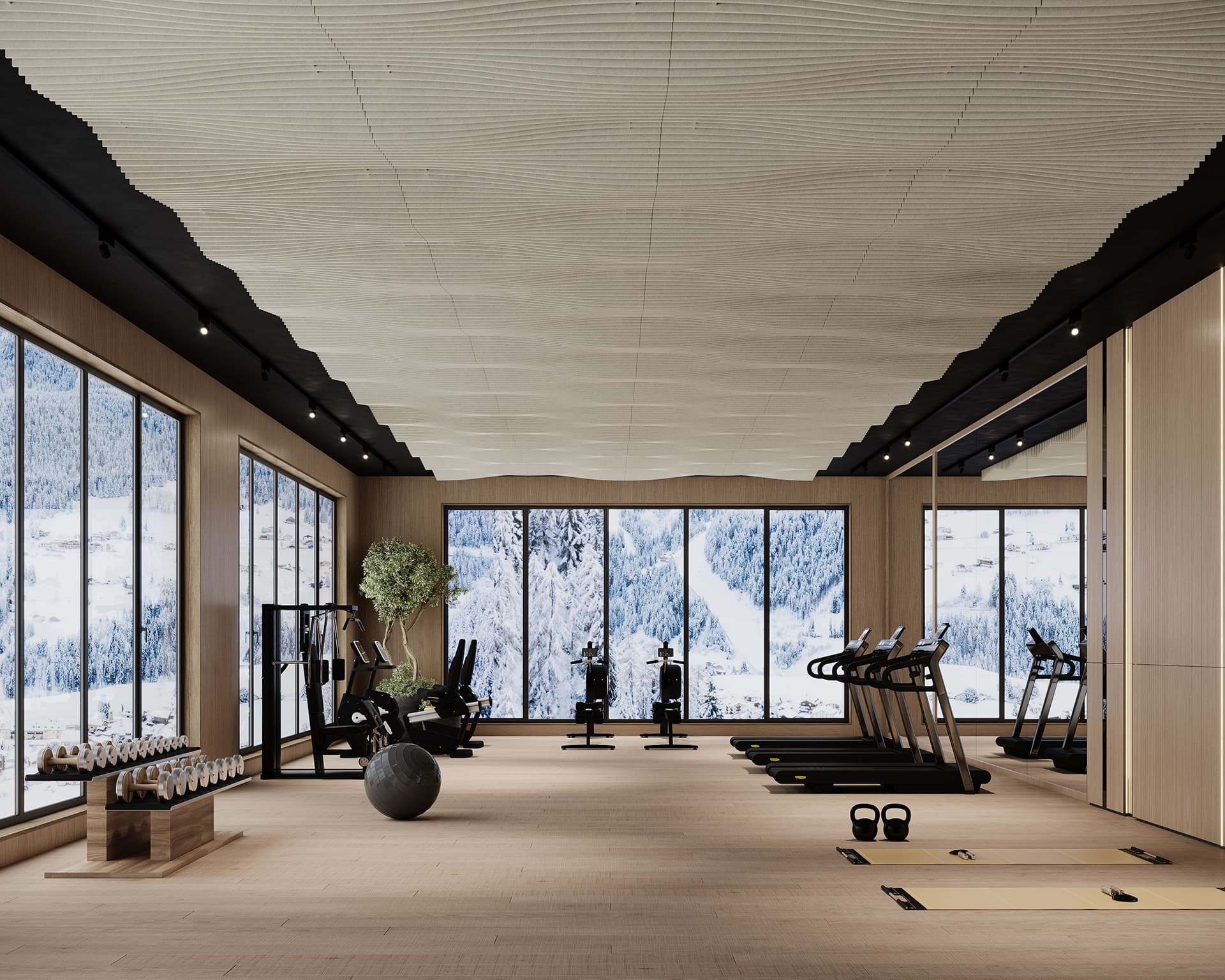 A modern gym with large windows showing a snowy mountain landscape, framed by an acoustic felt ceiling. The room features treadmills, exercise bikes, weights, a yoga area with mats, and a table with water bottles. Natural light illuminates the space, highlighting its clean design.