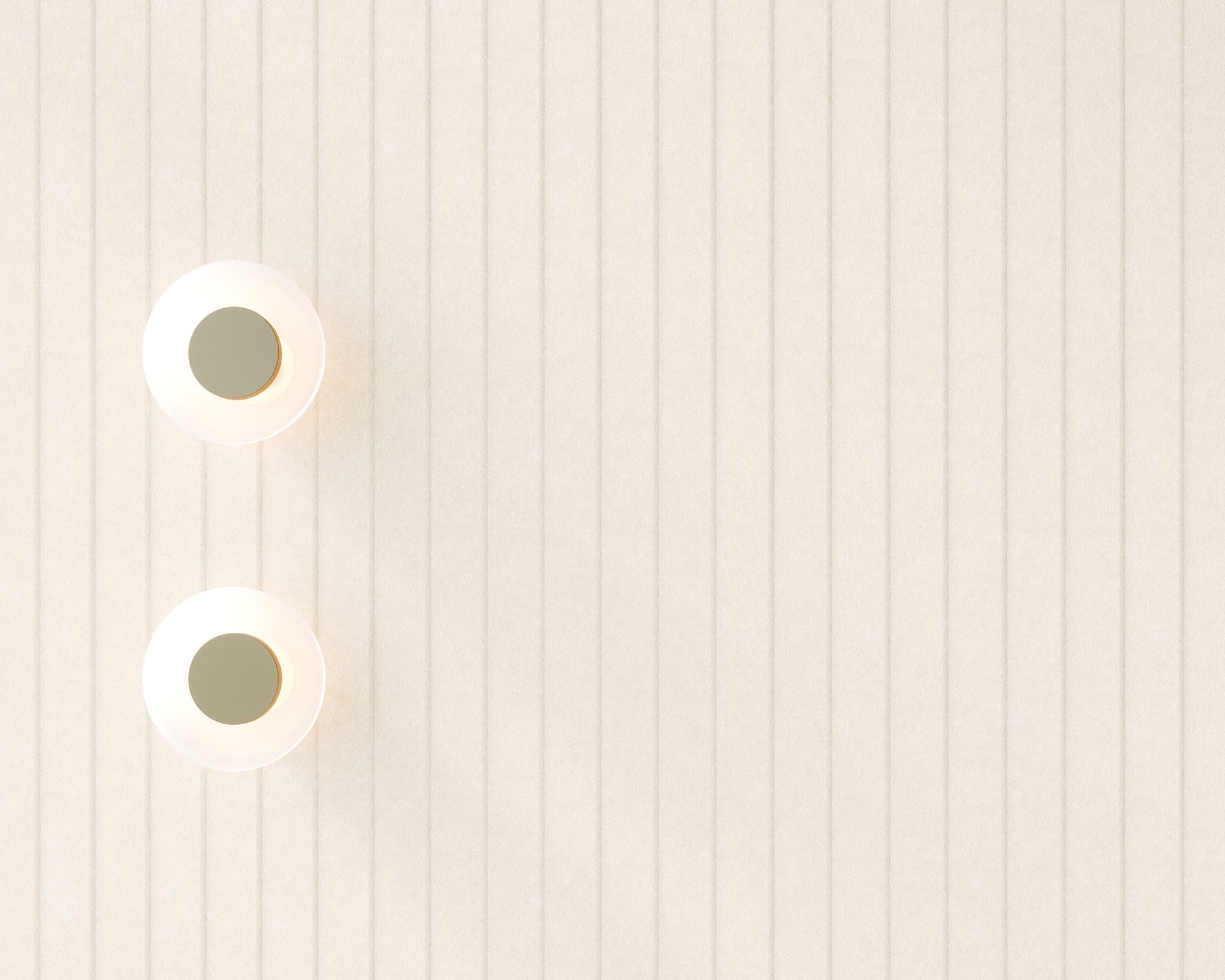 Two round ceiling lights are mounted on a textured beige acoustic felt wall. The design features vertical lines, and the lights emit a warm, soft glow, creating a minimalist and modern aesthetic. The lights are aligned vertically on the left side.