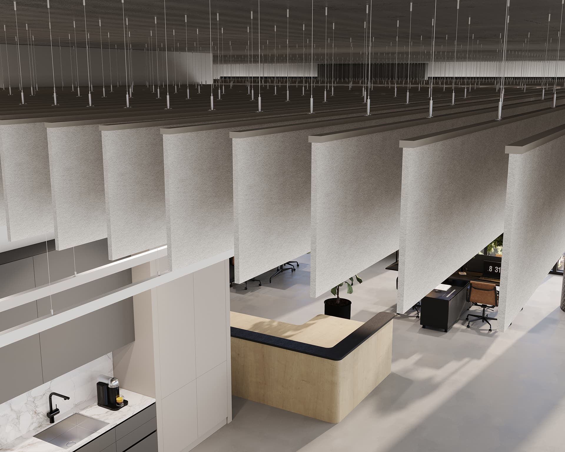 Modern office space with a minimalist design features hanging acoustic felt baffles, a light wood reception desk, and workstations. The area includes a kitchenette with a sink and espresso machine, with natural light illuminating the open floor plan.