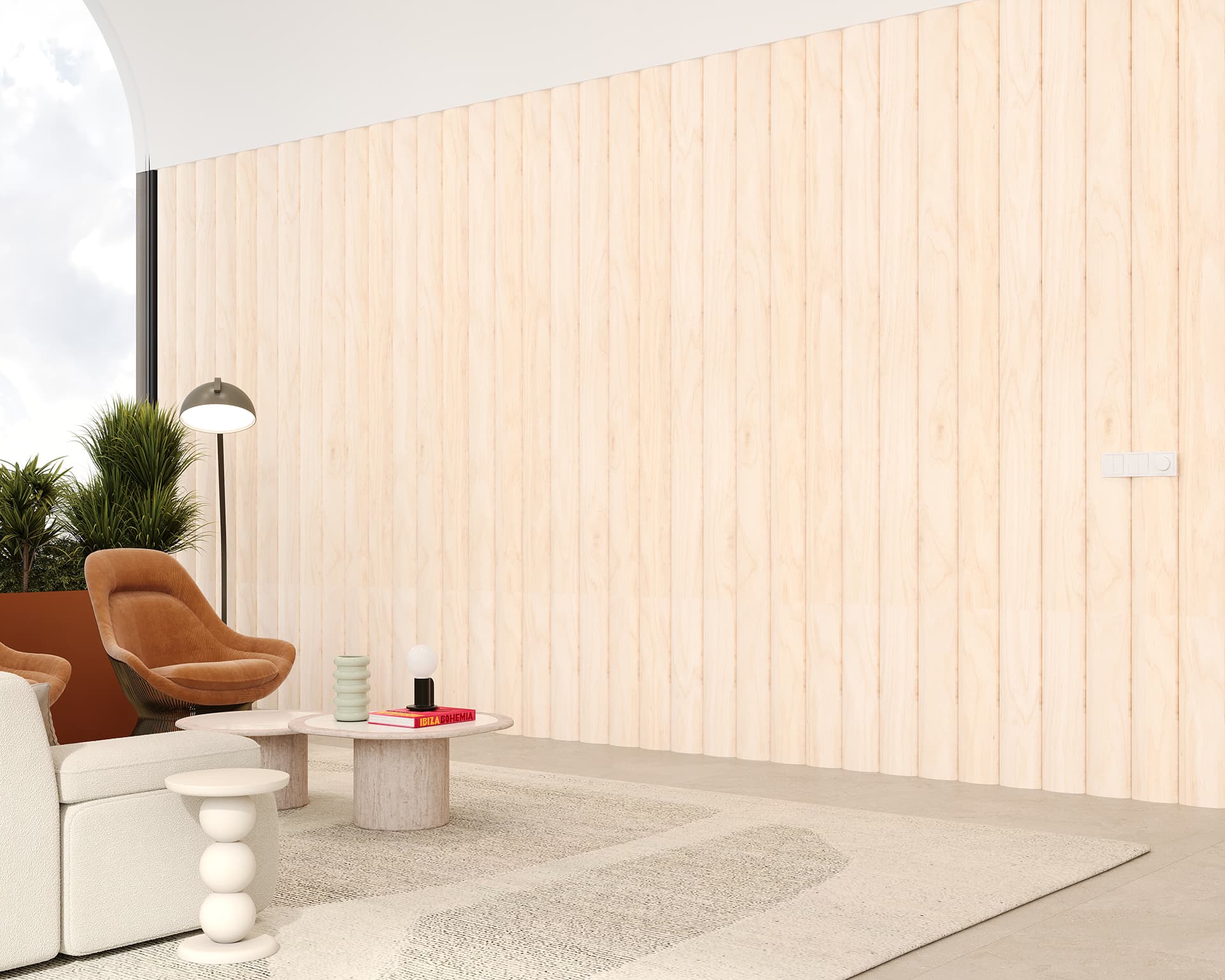 Modern living room with light woodgrain acoustic paneled walls and a large window. A beige sofa and brown armchair are paired with a round pink table. A floor lamp and potted plants add to the decor. A light rug covers part of the concrete floor.