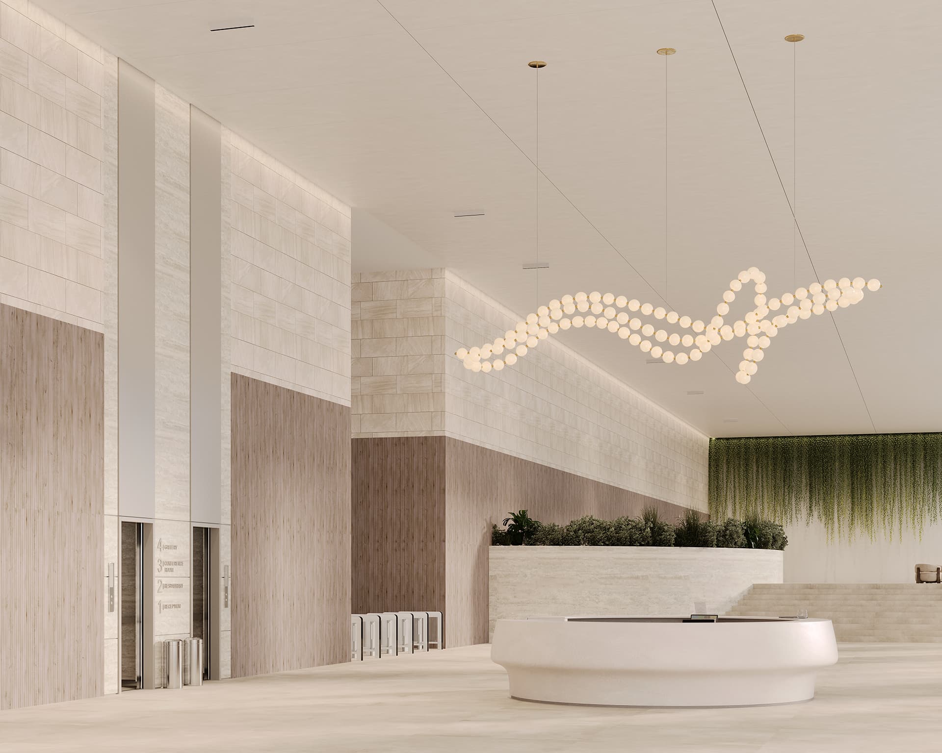A spacious, modern lobby with a tall ceiling. It features a curvy, elegant chandelier made of many small lights. The decor includes green plants along one wall and a sleek, circular reception desk at the center. Neutral tones and acoustic felt walls dominate the space.