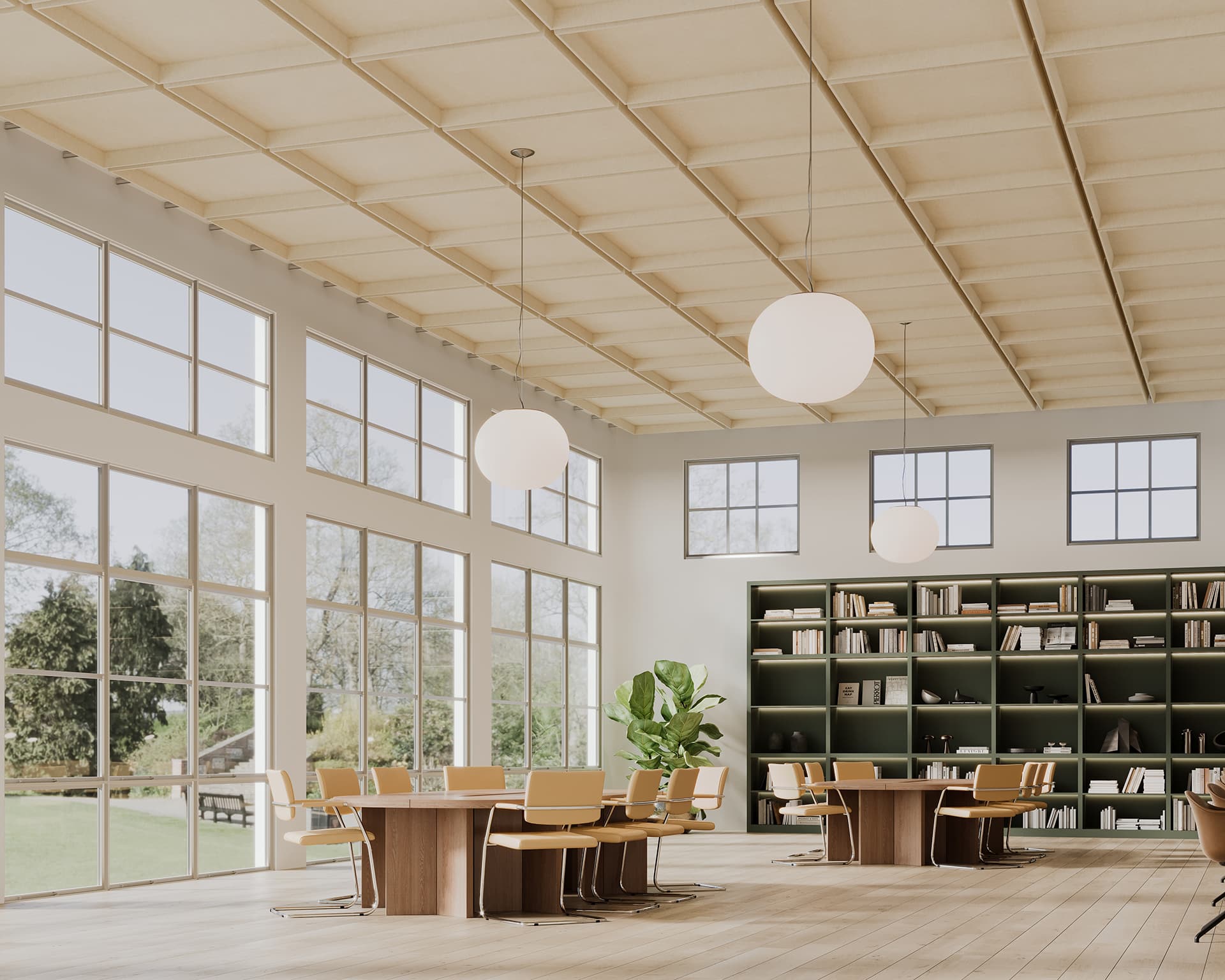 A spacious, well-lit library with large windows, wooden tables, and chairs. It features a bookshelf filled with books and a large plant. Round pendant lights hang from the acoustic felt ceiling, and greenery is visible through the windows.