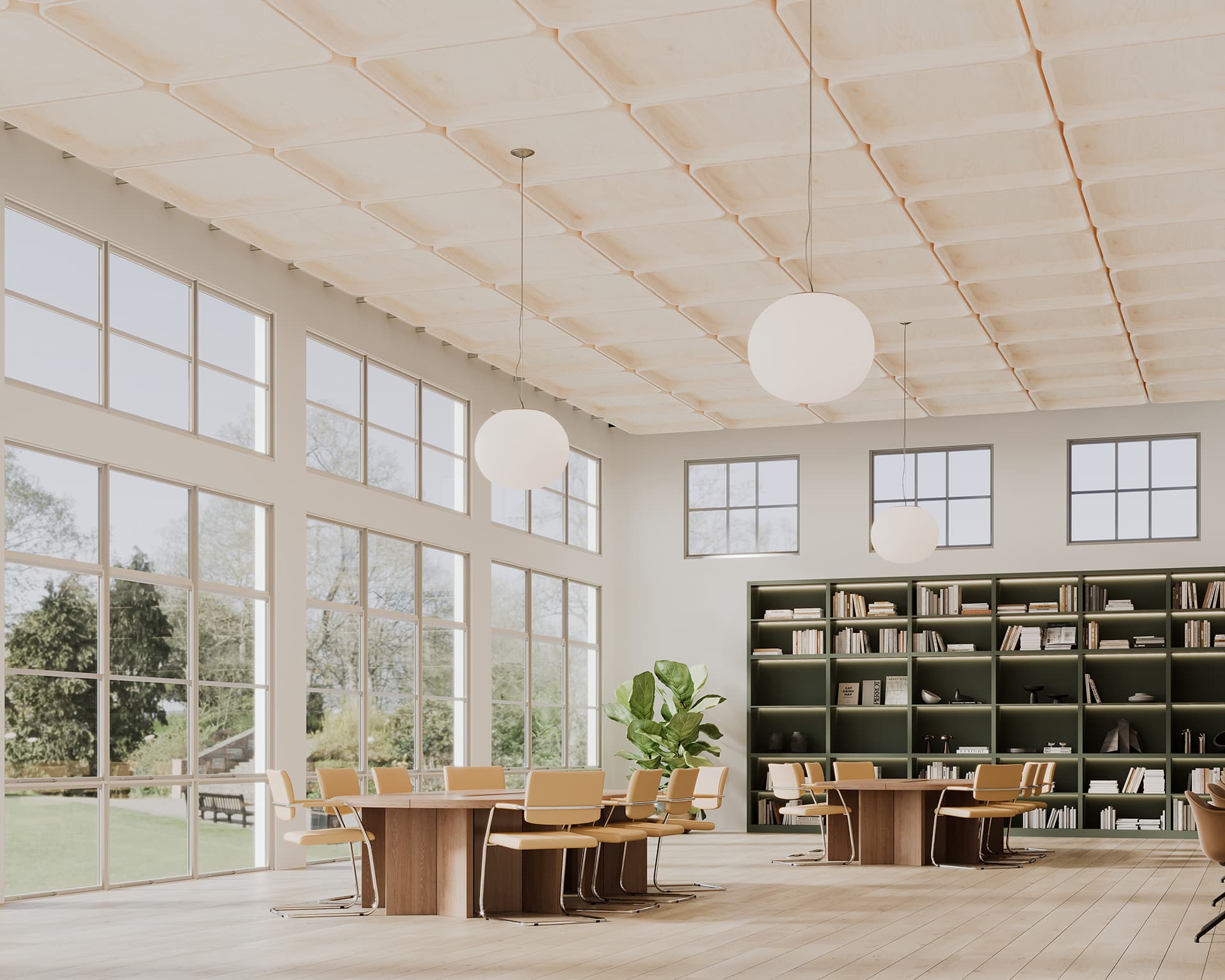 A bright room with large windows, a high acoustic felt ceiling, and wooden floors. It features several wooden tables with chairs, a large green bookshelf filled with books, round hanging lights, and a green plant near the window.
