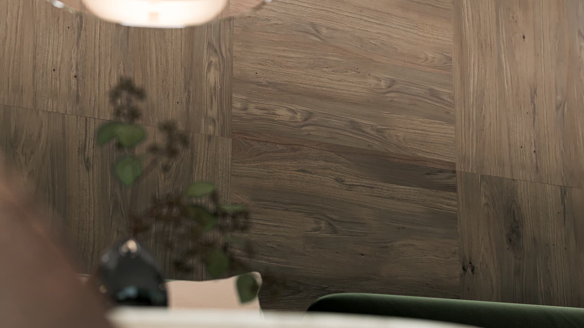 A cozy interior with a woodgrain acoustic felt wall, blurred hanging light, and partial view of a green couch and decorative plant in the foreground.
